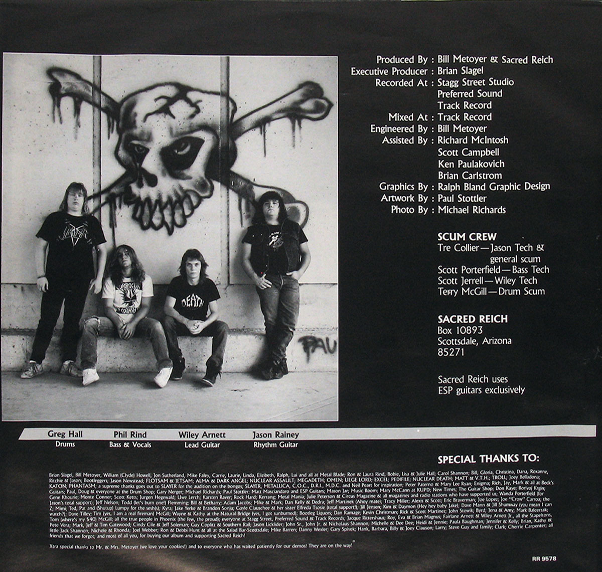 Sacred Reich Ignorance 1987 inner sleeve back. A black-and-white band photo of Sacred Reich members posing in front of a large graffiti-style skull and crossbones. The right side contains album production credits, recording details, and special thanks. The bottom section lists the band lineup with their respective roles.